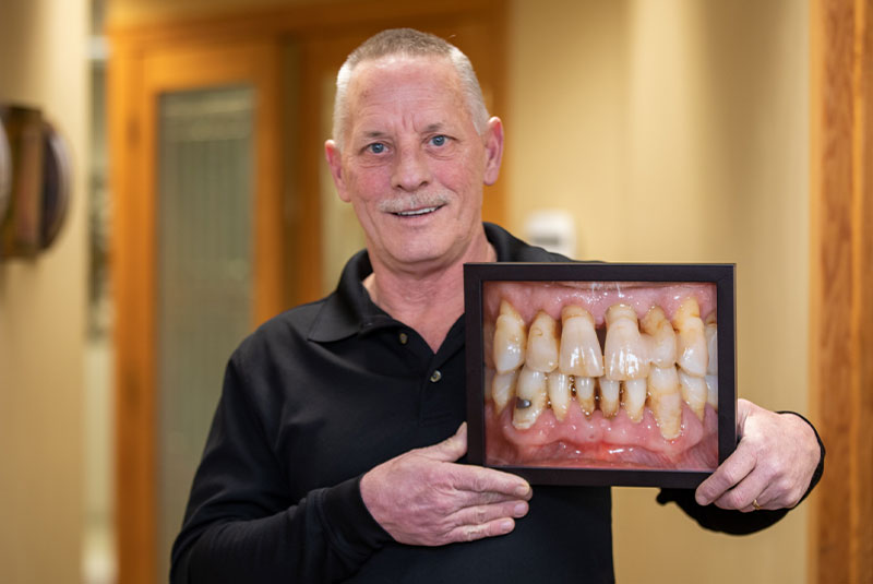 Patient smiling confidently after their dental implant procedure